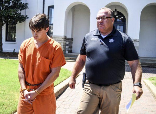 Brandon Theesfeld, left, is led from the Lafayette County Courthouse in Oxford, Miss., on July 23, 2019. (Bruce Newman/The Oxford Eagle via AP)
