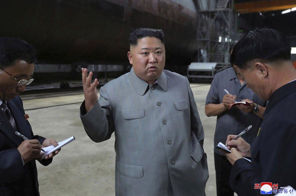 In this undated file photo provided on July 23, 2019, by the North Korean government, North Korean leader Kim Jong Un, center, speaks while inspecting a newly built submarine to be deployed soon, at an unknown location in North Korea. (Korean Central News Agency/Korea News Service via AP, File)
