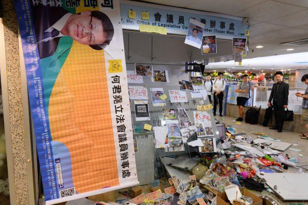 The office of pro-Beijing government lawmaker Junius Ho is seen shuttered and thrashed in Hong Kong’s Tsuen Wan district on July 22, 2019. (Song Bilong/The Epoch Times)