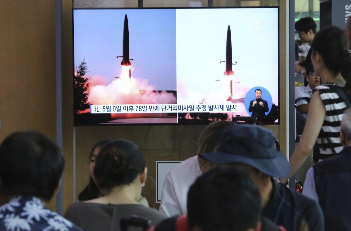 People watch a TV showing a file image of North Korea's missile launch during a news program at the Seoul Railway Station in Seoul, South Korea on July 25, 2019. (Ahn Young-joon/AP)