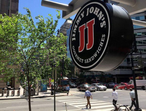 A logo of Jimmy John's, the sandwich restaurant chain specializing in delivery, hangs outside one of their shops in downtown Washington on June 9, 2016. (Mladen Antonov /AFP/Getty Images)