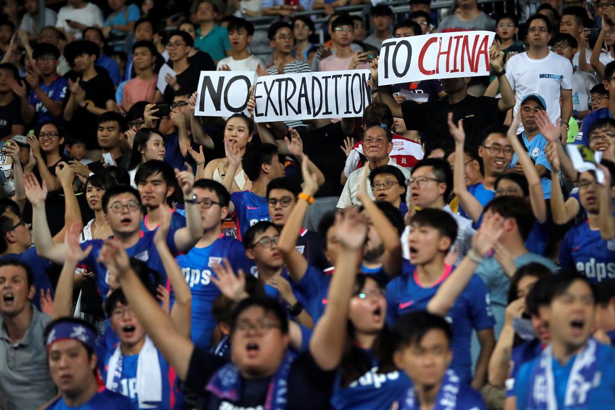 Fans hold an anti-extradition bill banner during a friendly match between Manchester City Football Club and Kitchee, in Hong Kong, China on July 24, 2019. (Tyrone Siu/Reuters)