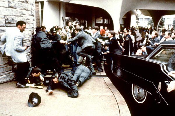 Police and Secret Service agents reacting during the assassination attempt on then US president Ronald Reagan, after a conference outside the Hilton Hotel in Washington, on March 30, 1981. (just behind the car). Reagan was hit in the chest and was hospitalized for 12 days. Hinckley was acquitted 21 June 1982 after a jury found him mentally unstable. (Mike Evens/AFP/Getty Images)