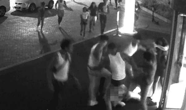 Surveillance footage shows a group of 14 teenage males and females assaulting tourists outside the Hilton Hotel in Washington on the early morning of July 14. (screenshot/Metropolitan Police Department)