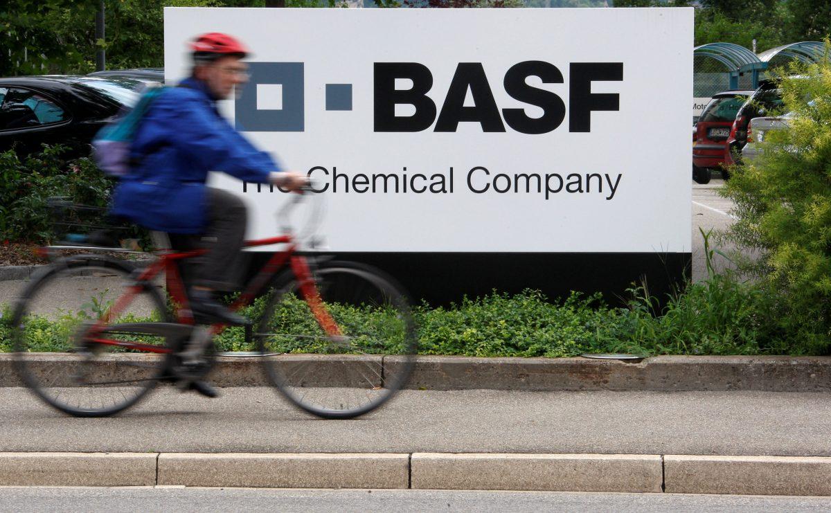 A cyclist rides past the entrance of the BASF plant and former Ciba production site in Schweizerhalle near Basel, Switzerland, on July 7, 2009. (Reuters)