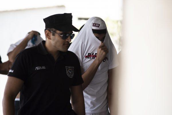 Israeli tourists, suspected of raping a 19-year-old British girl in Ayia Napa, arrive to the court premises with their faces covered in the eastern Cypriot resort of Paralimni on July 26, 2019, for a second hearing. (IAKOVOS HATZISTAVROU/AFP/Getty Images)