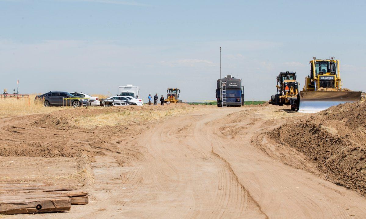 Authorities investigate the scene in the distance after oilfield workers discovered bones in rural Weld County in northern Colorado on July 24, 2019. (Michael Brian/Greeley Tribune via AP)