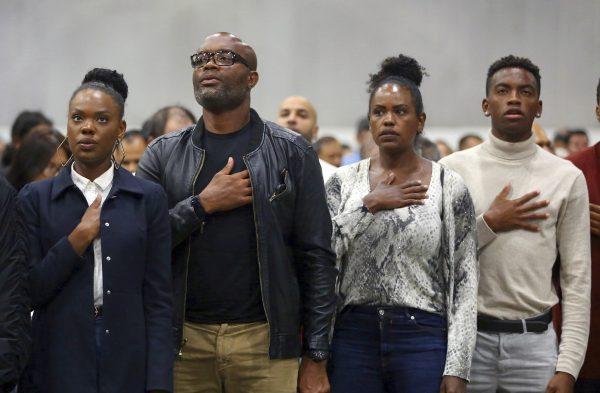 Mixed martial arts great Anderson "Spider" Silva of Brazil, his daughter Kaory, 23 (L), his wife Dayane and son Kalyl, 20 (R), recite the Pledge of Allegiance after all but Dayane were sworn in as U.S. citizens in a mass naturalization ceremony on July 23, 2019 at the Los Angeles Convention Center. (Reed Saxon/AP)