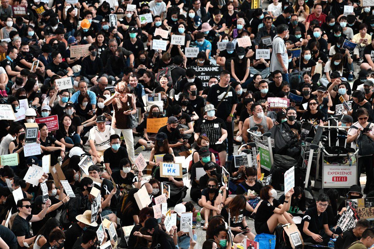 Protesters rally against a controversial extradition bill in the arrivals hall at the international airport in Hong Kong on July 26, 2019. (Anthony Wallace/AFP/Getty Images)