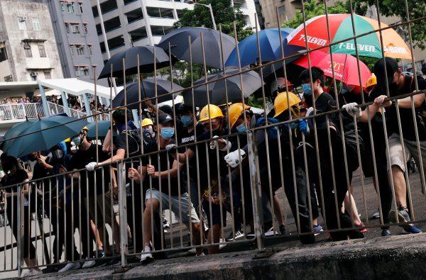 Protesters pull down a fence near Nam Pin Wai village during a protest against the Yuen Long attacks in Yuen Long, New Territories, Hong Kong, China, on July 27, 2019. (Tyrone Siu/Reuters)