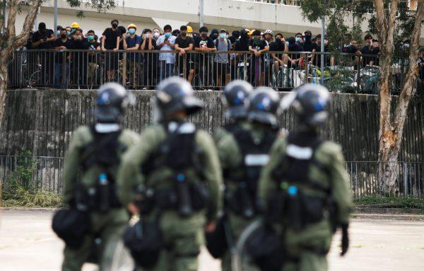 Police officers stand guard outside Nam Pin Wai village during a protest against the Yuen Long attacks in Yuen Long, New Territories, Hong Kong, China, on July 27, 2019. (Edgar Su/Reuters)
