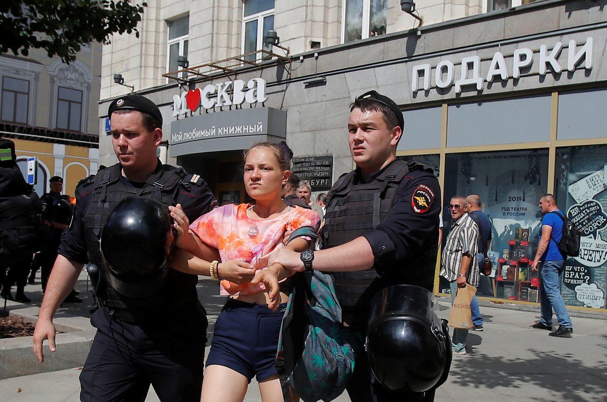 Law enforcement officers detain a woman during a rally calling for opposition candidates to be registered for elections to Moscow City Duma, the capital's regional parliament, in Moscow, Russia, on July 27, 2019. (Maxim Shemetov/Reuters)