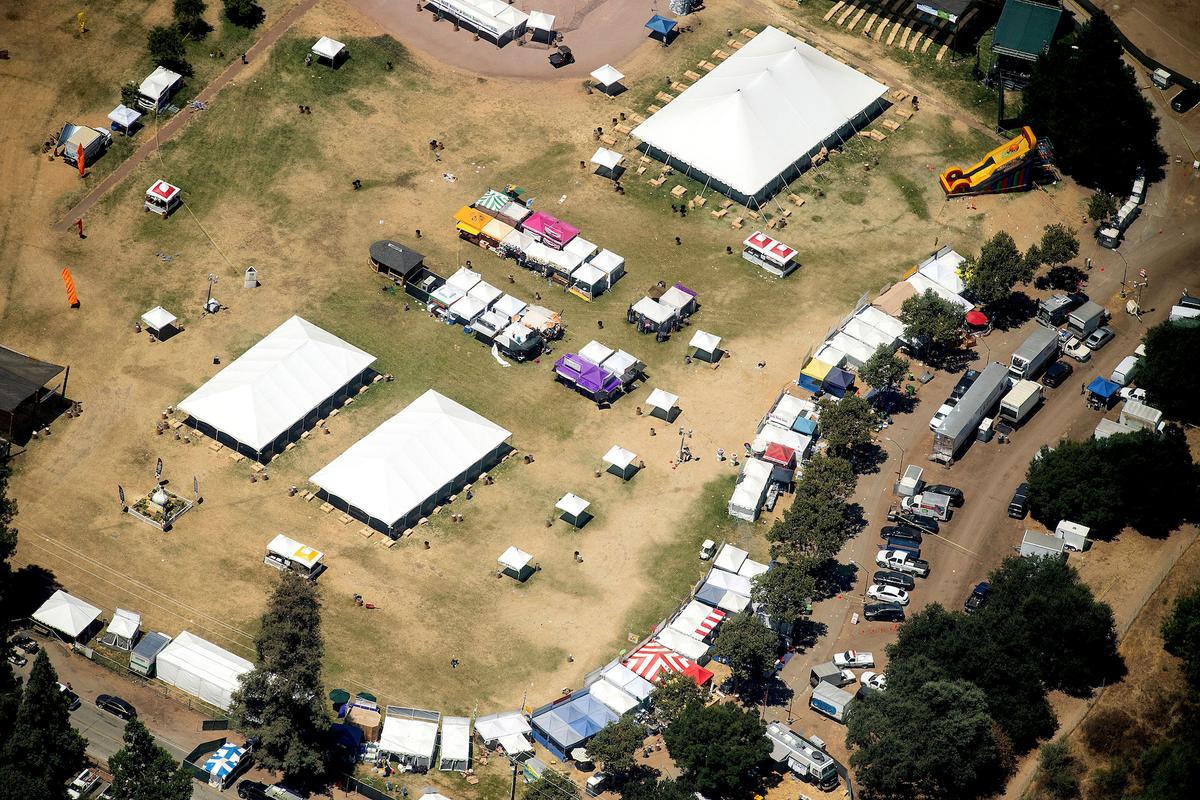 In this aerial photo, vendor booths line Christmas Hill Park, July 29, 2019, in Gilroy, Calif., the site of a shooting the day before at the Gilroy Garlic Festival. (AP Photo/Noah Berger)
