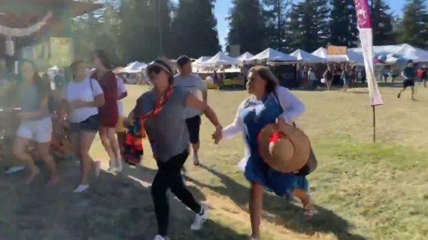 People run as an active shooter was reported at the Gilroy Garlic Festival, south of San Jose, Calif., on July 28, 2019 in this still image taken from a social media video. (Twitter @wavyia/Social Media via Reuters)