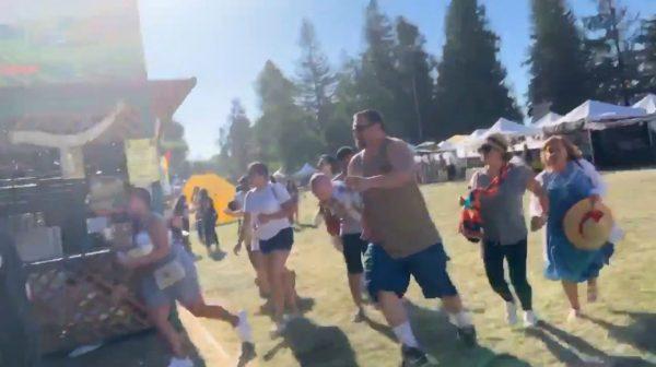 People run as an active shooter was reported at the Gilroy Garlic Festival, south of San Jose, Calif., on July 28, 2019 in this still image taken from a social media video. (Courtesy of Twitter @wavyia via Reuters)