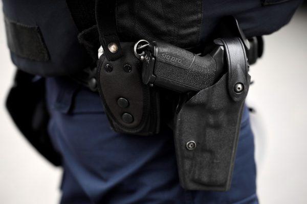 A stock photo shows a police officer wearing a SIG-Sauer pistol. (Lionel Bonaventure/AFP/Getty Images)