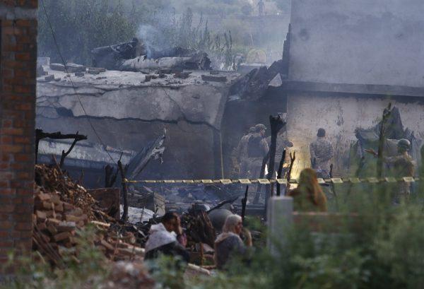 Pakistan army officials examine the site of a plane crash in Rawalpindi, Pakistan on July 30, 2019. (Anjum Naveed/AP Photo)