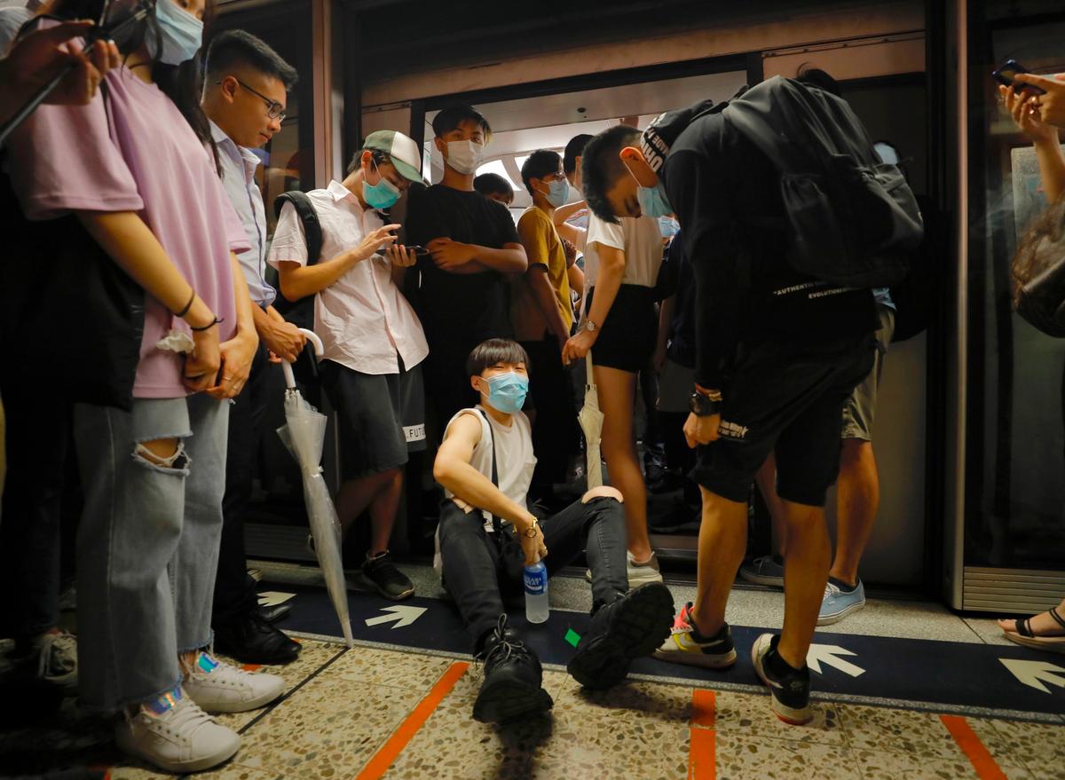 Protesters block train car doors in Hong Kong on July 30, 2019. (Vincent Yu/AP)