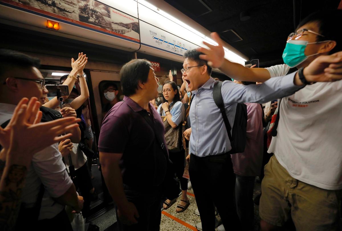 Passengers argue with protesters who disrupted a subway line in Hong Kong on July 30, 2019. (Vincent Yu/AP)