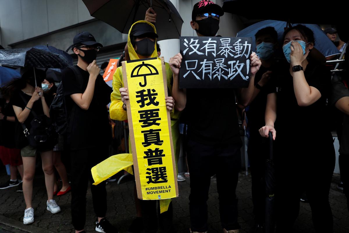 Supporters gather outside the Eastern Courts to support the arrested anti-extradition bill protesters who face rioting charges, in Hong Kong, China on July 31, 2019. The placard reads, "There are no thugs, only tyranny." (Tyrone Siu/Reuters)