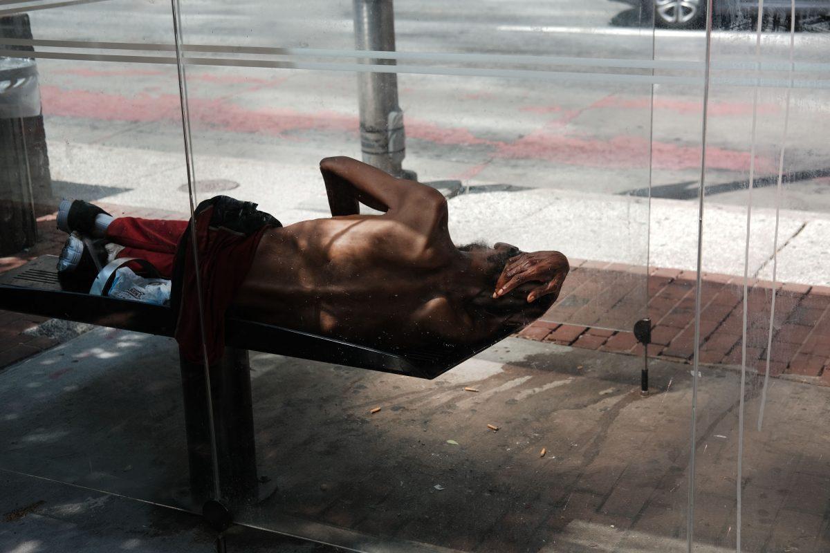 A man sleeps on a bench in downtown Baltimore, Md., on July 28, 2019. (Spencer Platt/Getty Images)