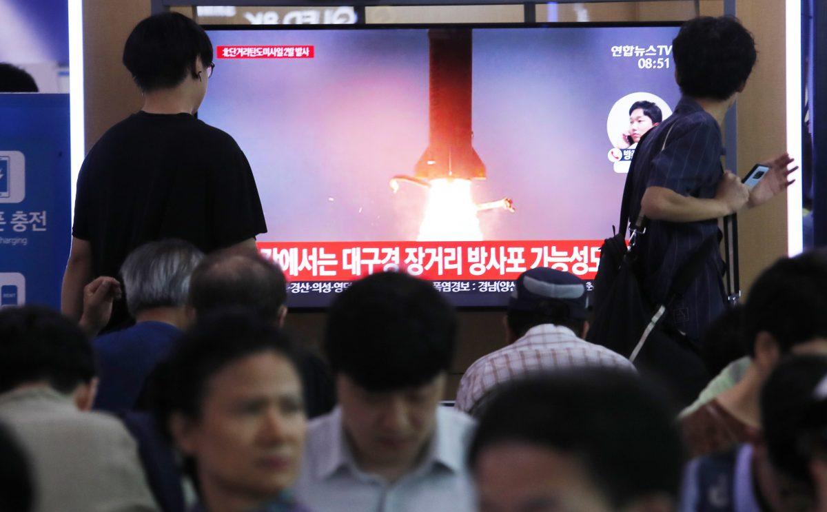 People watch a TV showing a file image of North Korea's missile launch during a news program at the Seoul Railway Station in Seoul, South Korea on July 31, 2019. (AP Photo/Ahn Young-joon)