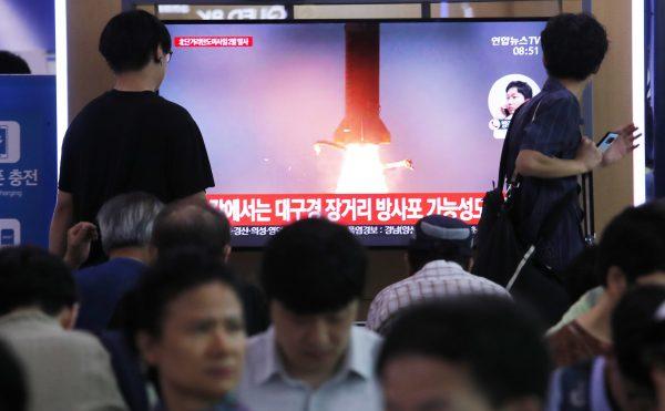 People watch a TV showing a file image of North Korea's missile launch during a news program at the Seoul Railway Station in Seoul, South Korea on July 31, 2019. (Ahn Young-joon/AP Photo)