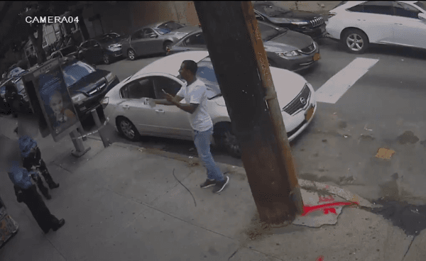 Two traffic officers were standing near Jamaica Avenue and 86th Street on July 24 afternoon when a man walked over and sprayed water on them. (screenshot/NYPD Crime Stoppers)