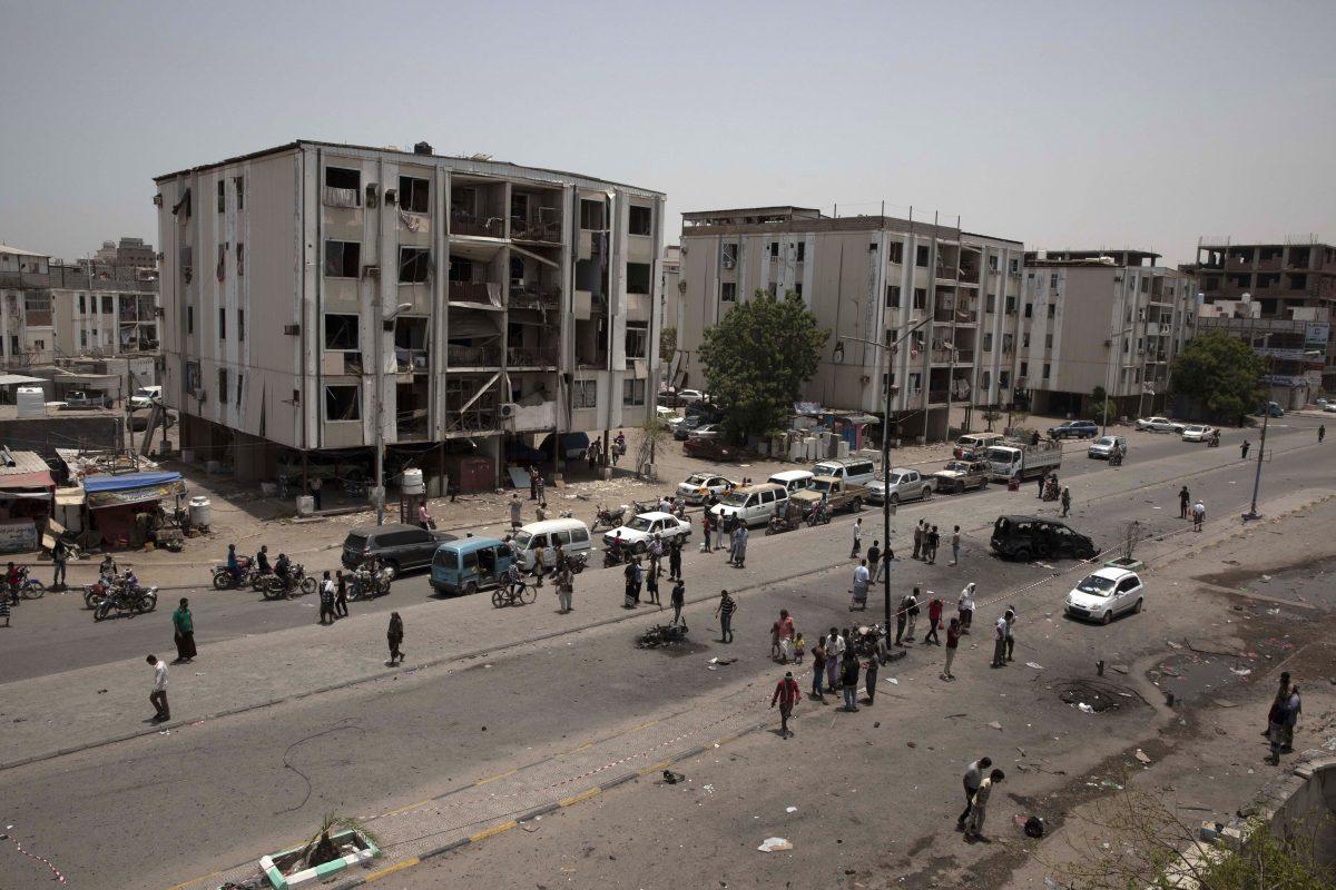 Civilians and security forces gather at the site of a deadly attack on the Sheikh Othman police station, in Aden, Yemen on Aug. 1, 2019. (Nariman El-Mofty/AP Photo)