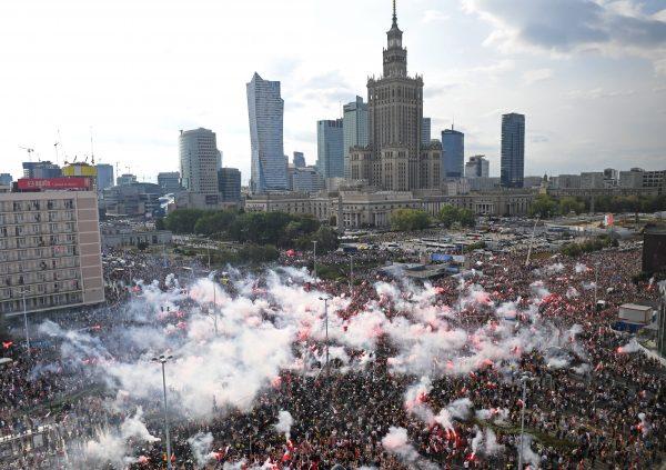 People light flares as they observe a minute of silence to mark the 75th anniversary of the Warsaw Uprising against Nazi German occupiers during World War II in Warsaw, Poland, on Aug. 1, 2019 (Janek Skarzynski/AFP/Getty Images)