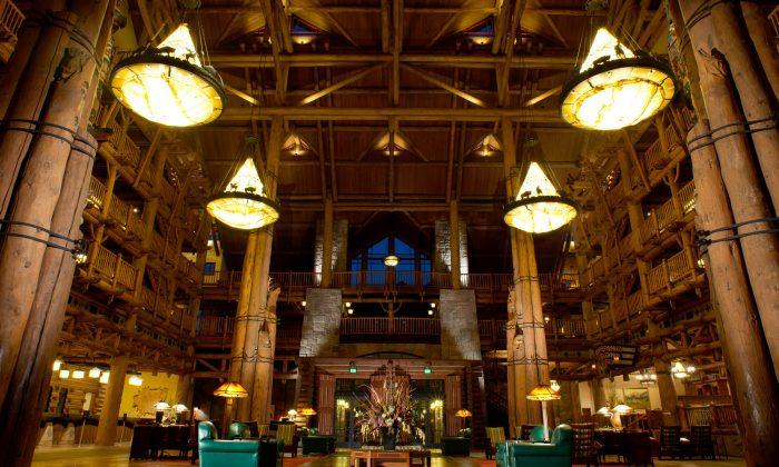 Disney's Wilderness Lodge features a six-story lobby, with teepee-topped chandeliers, totem poles, an 82-foot-tall stone fireplace, and a bubbling hot spring that expands outside the building into a waterfall. (Disney)