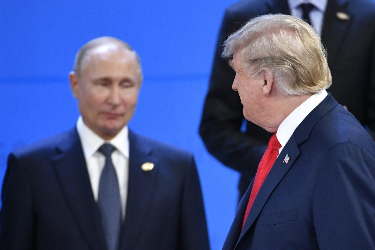 U.S. President Donald Trump (R) looks at Russia's President Vladimir Putin as they take their places for a group photo during the G20 Leaders' Summit in Buenos Aires, on Nov. 30, 2018. (Alexander Nemenov/AFP/Getty Images)