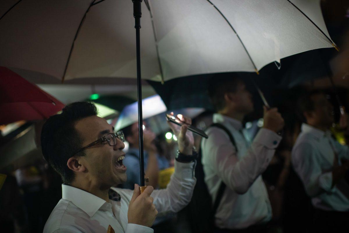 People from the finance community hold up umbrellas and shine lights during a rally against a controversial extradition bill in Hong Kong, on Aug. 01, 2019. (Billy H.C. Kwok/Getty Images)