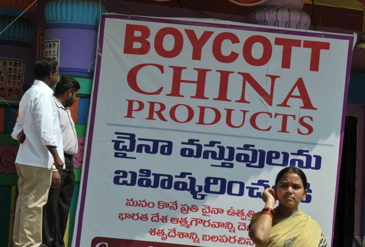 Members of the Ganesh Utsav Committee stand alongside a poster declaring 'Boycott China Products' in Hyderabad, India, on Nov. 3, 2016. (Noah Seelam/AFP/Getty Images)
