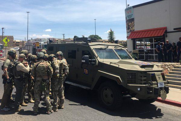 Armed police officers gather next to an FBI armored vehicle next to the Cielo Vista Mall amid an active shooter situation in El Paso on Aug. 3, 2019. (Angel Juarez/AFP/Getty Images)