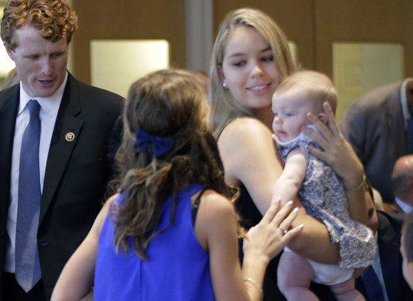 Saoirse Kennedy Hill, right, granddaughter of Ethel Kennedy and her late husband Robert F. Kennedy, holds a relative's baby before a ceremony for naming the Robert Kennedy Navy Ship at the John F. Kennedy Presidential Library, in Boston on Sept. 20, 2016. (Elise Amendola/AP Photo)