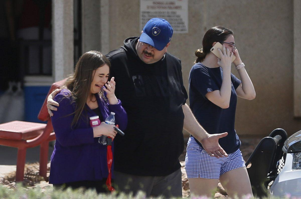 People arrive at MacArthur Elementary looking for family and friends as the school is being used a re-unification center during the aftermath of a shooting at the Walmart near the Cielo Vista Mall, in El Paso, Texas on Aug. 3, 2019. (Briana Sanchez/The El Paso Times via AP)