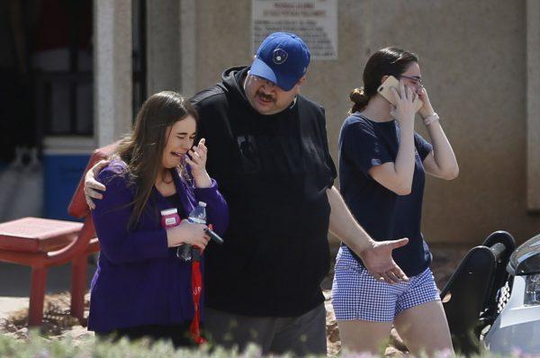 People arrive at MacArthur Elementary looking for family and friends as the school is being used as a re-unification center during the aftermath of a shooting at the Walmart near the Cielo Vista Mall, in El Paso, Texas on Aug. 3, 2019. (Briana Sanchez/The El Paso Times via AP)