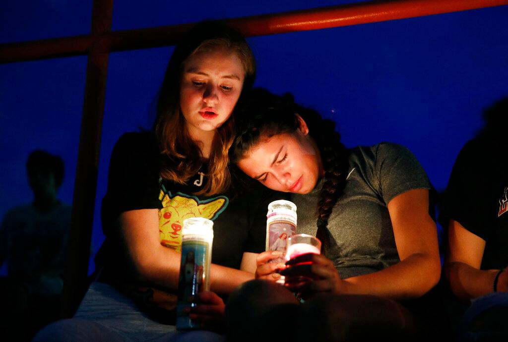 Melody Stout and Hannah Payan comfort each other during a vigil for victims of the shooting that occurred earlier in the day at a shopping center in El Paso, Texas, on Aug. 3, 2019. (John Locher/AP Photo)
