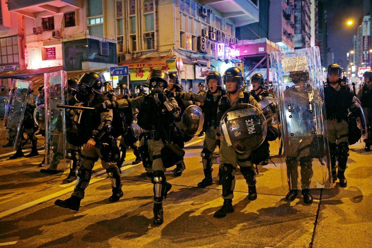 Police officers walk on a street after they dispersed anti-extradition bill protesters, in Hong Kong, on Aug. 3, 2019. (Eloisa Lopez/Reuters)