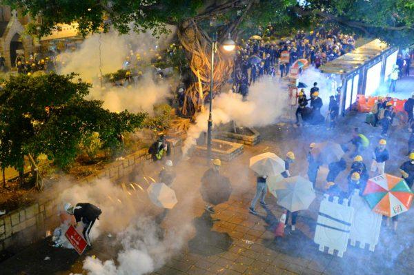 Protesters brave tear gas fired by local police officers in a protest in Hong Kong on Aug. 3, 2019. (Song Bilong/The Epoch Times)