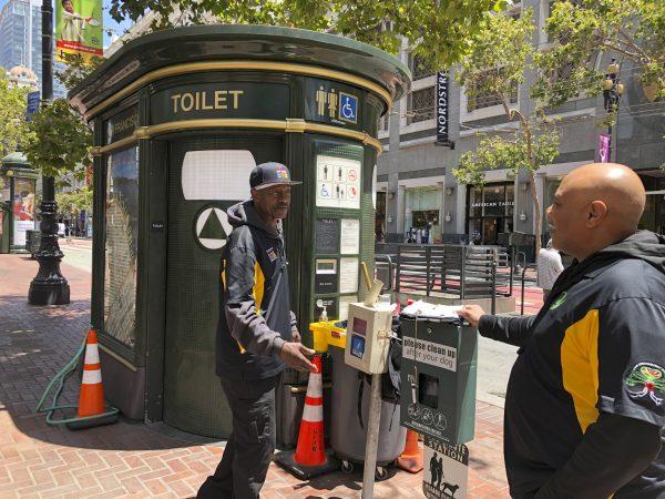 Nelson Butler, right, greets Lester "Smokey" Williams at one of the 25 "Pit Stop" locations in San Francisco, on July 18, 2019. (Janie Har/AP Photo)