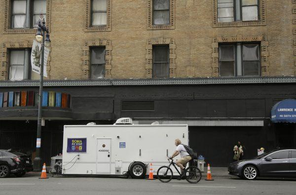 A man rides his bicycle past a "Pit Stop" public toilet on Sixth Street, in San Francisco, on Aug. 1, 2019. (Eric Risberg/AP Photo)