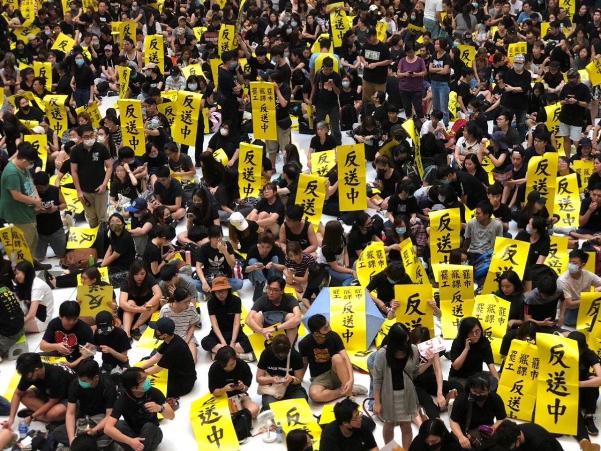 Protesters holding banners opposing the extradition bill in Hong Kong's New Town Plaza on Aug. 5, 2019. (Juliana Chu/The Epoch Times)