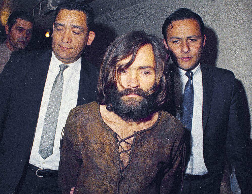 Charles Manson is escorted to his arraignment on conspiracy-murder charges in connection with the Sharon Tate murder case in Los Angeles, in 1969. (AP Photo)