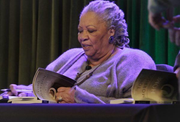 Author Toni Morrison signs copies of her latest book "Home," during Google's online program series, Authors At Google, in New York, on Feb. 27, 2013. (Bebeto Matthews, File/AP Photo)