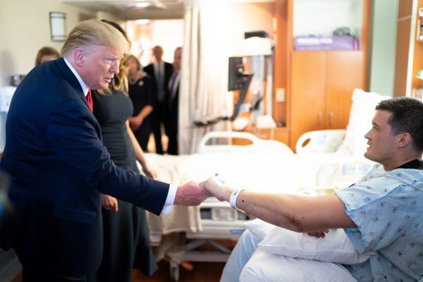 President Donald Trump and First Lady Melania Trump meet with a survivor of the Dayton shooting massacre on August 7, 2019, at Miami Valley Hospital in Dayton, Ohio. (Official White House Photo by Andrea Hanks)