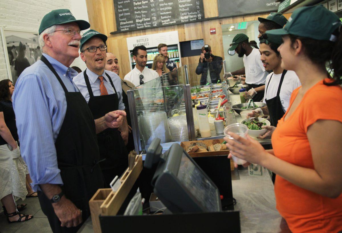Labor Secretary Thomas Perez (2nd L) and Representative George Miller (D-CA) (L) order food at a sweetgreen restaurant at Dupont Circle in Washington, DC.on June 16, 2014 (Photo by Alex Wong/Getty Images)