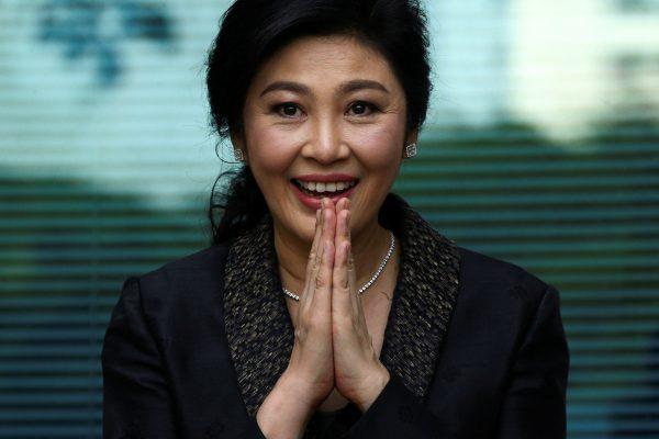 Ousted former Thai prime minister Yingluck Shinawatra greets supporters as she arrives at the Supreme Court in Bangkok, Thailand, on Aug. 1, 2017. (Athit Perawongmetha/Reuters)