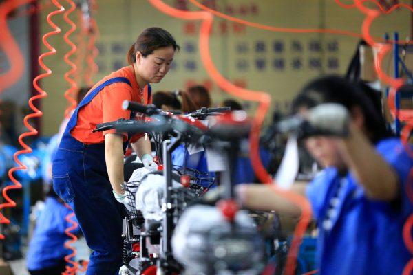Workers manufacturing electric bicycles at a factory in Huaian, Jiangsu Province, China on May 26, 2019. (Reuters)